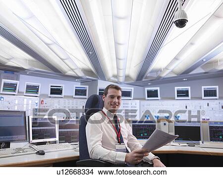 Picture - Operator in control room. Fotosearch