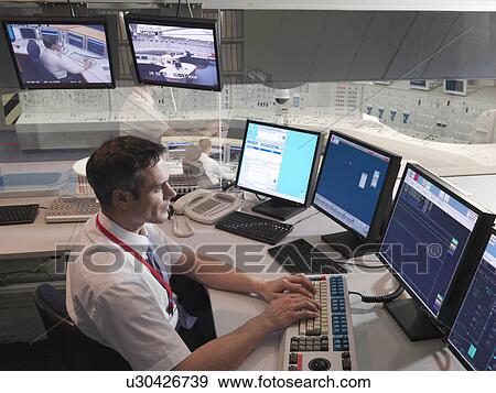 Operator in control room View Large Photo Image Stock Photo - Operator in control room. Fotosearch