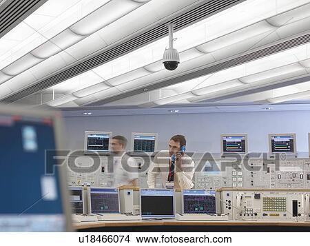 Picture - Operator on telephone in control room. Fotosearch