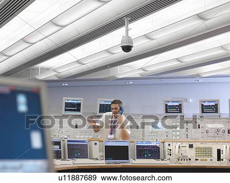 Stock Photo - Operator on telephone in control room. Fotosearch