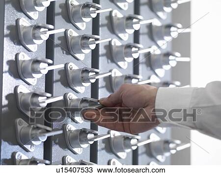 Stock Image - Operator turning key. Fotosearch