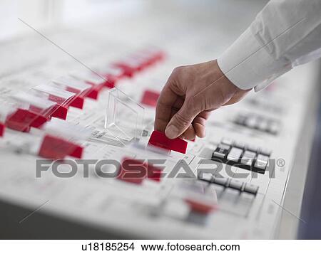 Picture - Operator turning red switch. Fotosearch