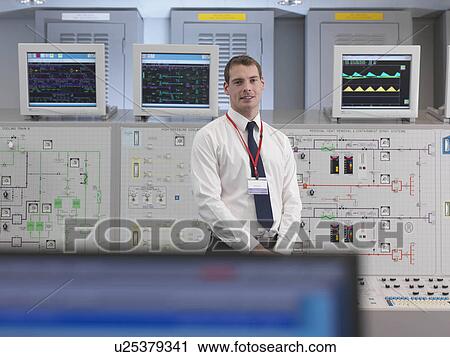 Stock Image - Operator with screens in control room. Fotosearch