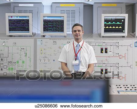 Stock Photograph - Operator with screens in control room. Fotosearch