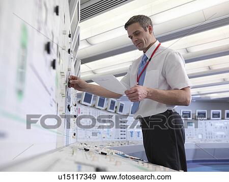 Stock Photo - Operator working in control room. Fotosearch