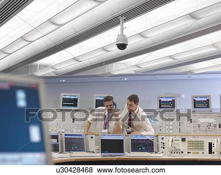 Stock Photo - Operators on telephone in control room. Fotosearch