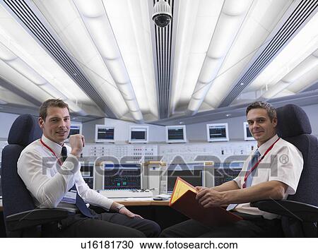 Operators seated in control room View Large Photo Image Stock Image - Operators seated in control room. Fotosearch