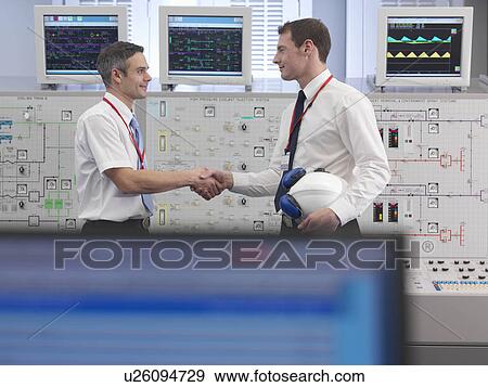 Operators shaking hands in control room View Large Photo Image Stock Photo - Operators shaking hands in control room. Fotosearch