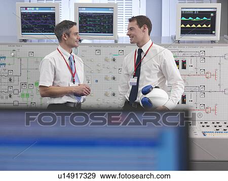 Operators talking in control room View Large Photo Image Stock Photo - Operators talking in control room. Fotosearch