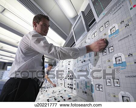 Stock Photo - Operators working in control room. Fotosearch