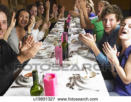 Stock Photo - "People at table, clapping hands". Fotosearch