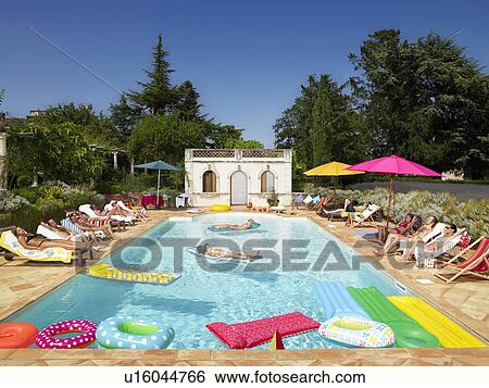 People enjoying summer around the pool View Large Photo Image Stock Photograph - People enjoying summer around the pool. Fotosearch