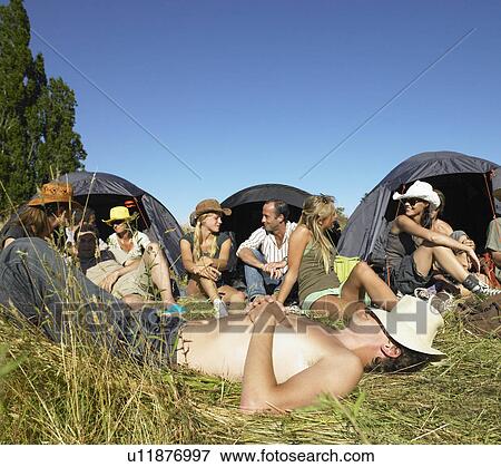 Stock Photo - "People in a field, backpacking tents". Fotosearch
