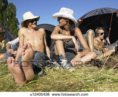 Stock Photo - "People in a field, backpacking tents". Fotosearch