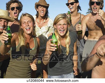 "People in a field, raising their beer" View Large Photo Image Picture - "People in a field, raising their beer". Fotosearch