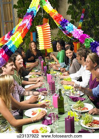 "People sitting at table, celebrating" View Large Photo Image Stock Image - "People sitting at table, celebrating". Fotosearch