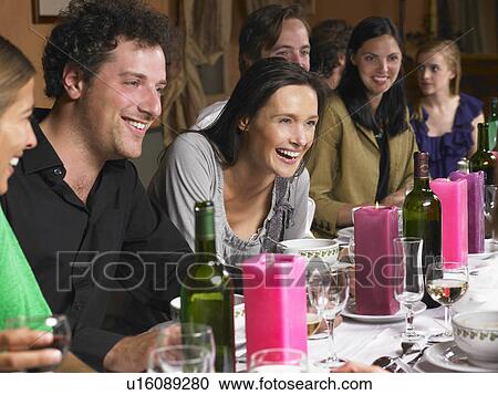 Stock Image - People talking during dinner. Fotosearch