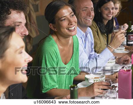 Stock Image - People talking during dinner. Fotosearch