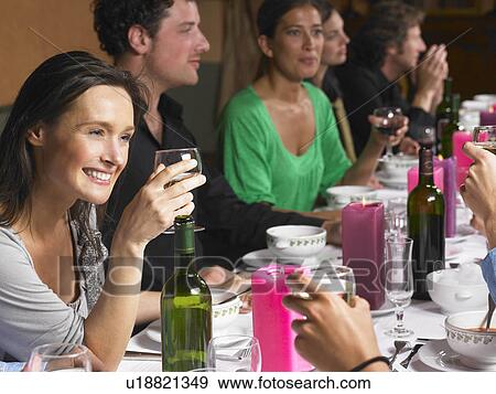 Stock Photo - People talking during dinner. Fotosearch