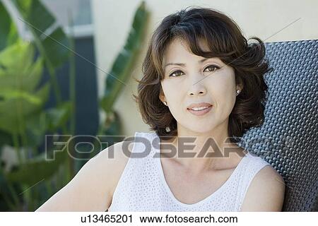 Stock Image - Portrait of confident mature woman. Fotosearch