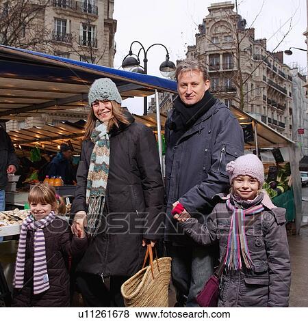 Stock Photo - Portrait of family at outdoor market. Fotosearch