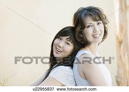 Stock Photo - Portrait of happy mother and daughter. Fotosearch