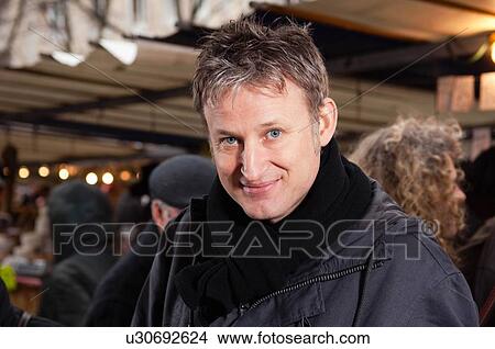 Picture - Portrait of man at street market. Fotosearch