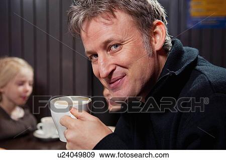 Stock Photo - Portrait of man with chocolate mug. Fotosearch