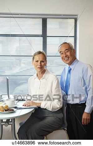 Portrait of senior co-workers in cafe View Large Photo Image Stock Photograph - Portrait of senior co-workers in cafe. Fotosearch