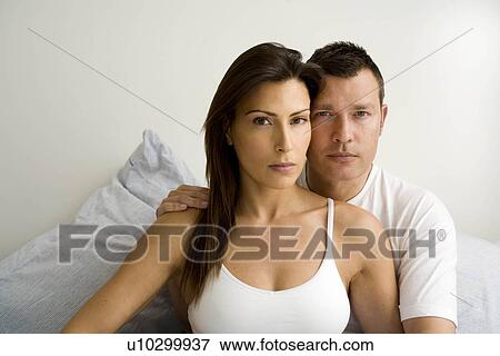 Stock Photo - Portrait of young couple at home. Fotosearch