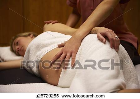 Stock Photography - Pregnant woman being massaged. Fotosearch