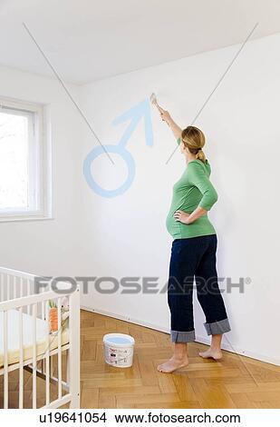 Pregnant woman painting nursery View Large Photo Image Picture - Pregnant woman painting nursery. Fotosearch
