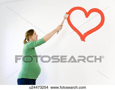 Pregnant woman painting nursery View Large Photo Image Picture - Pregnant woman painting nursery. Fotosearch