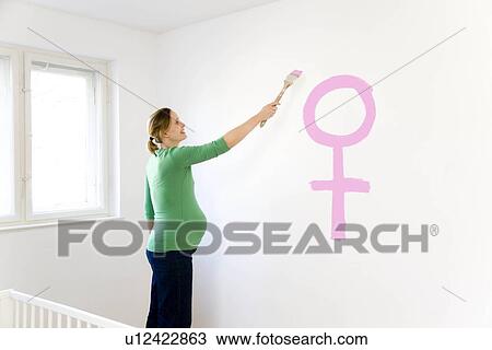 Pregnant woman painting nursery View Large Photo Image Stock Image - Pregnant woman painting nursery. Fotosearch