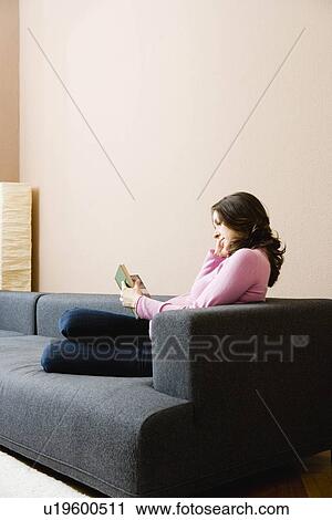 Stock Image - Pregnant woman reading a book. Fotosearch