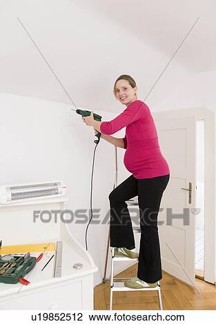 Pregnant woman with power drill View Large Photo Image Stock Image - Pregnant woman with power drill. Fotosearch
