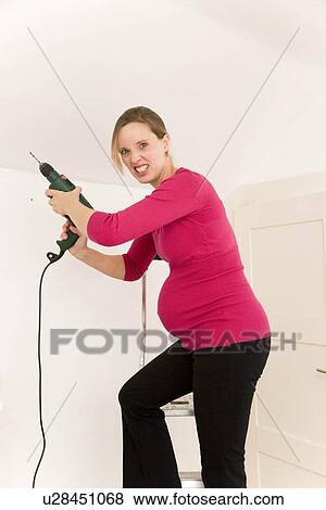 Pregnant woman with power drill View Large Photo Image Stock Photo - Pregnant woman with power drill. Fotosearch