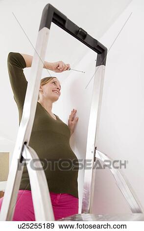 Pregnant woman with screwdriver View Large Photo Image Stock Photo - Pregnant woman with screwdriver. Fotosearch