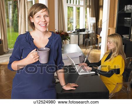 Stock Image - Pregnant women at work. Fotosearch