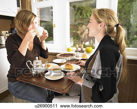 Stock Image - Pregnant women having tea. Fotosearch