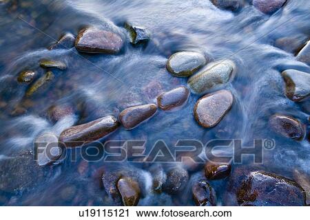 Rock sculpture of arrow symbol in river View Large Photo Image Stock Image - Rock sculpture of arrow symbol in river. Fotosearch