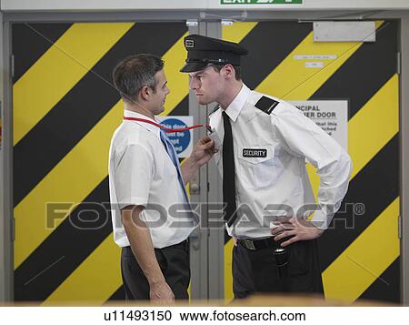 Stock Image - Security guard checking security tag. Fotosearch