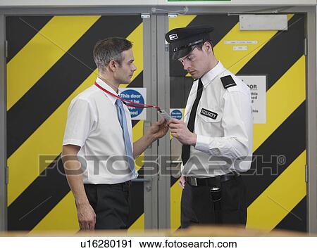Security guard checking security tag View Large Photo Image Stock Image - Security guard checking security tag. Fotosearch