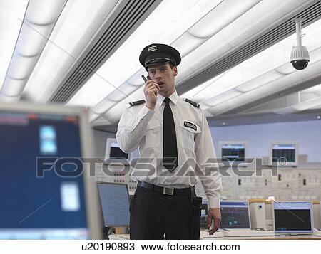 Security guard talking on radio View Large Photo Image Stock Image - Security guard talking on radio. Fotosearch
