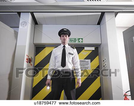 Stock Photo - Security guard with torch. Fotosearch