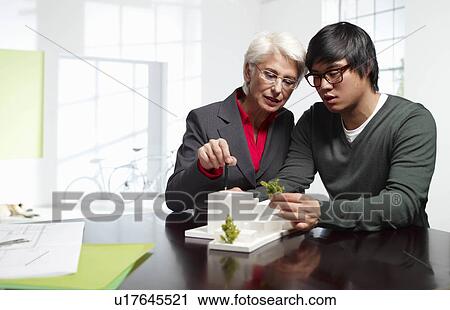 Senior and junior architects at work View Large Photo Image Stock Image - Senior and junior architects at work. Fotosearch