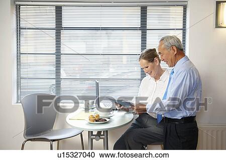 Senior co-workers having casual meeting View Large Photo Image Stock Image - Senior co-workers having casual meeting. Fotosearch