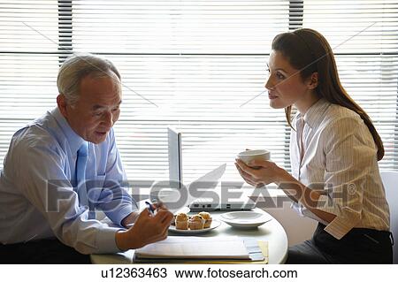 Senior man and woman working in cafe View Large Photo Image Stock Image - Senior man and woman working in cafe. Fotosearch