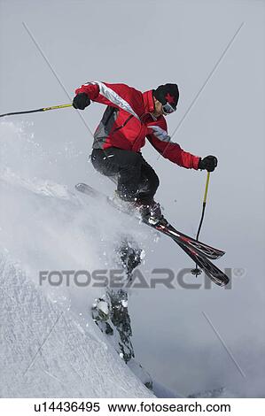 Skier jumping of a rock View Large Photo Image Stock Photography - Skier jumping of a rock. Fotosearch