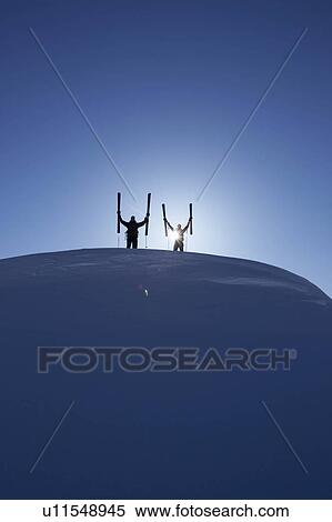 Stock Photography - Skiers on top of mountain. Fotosearch